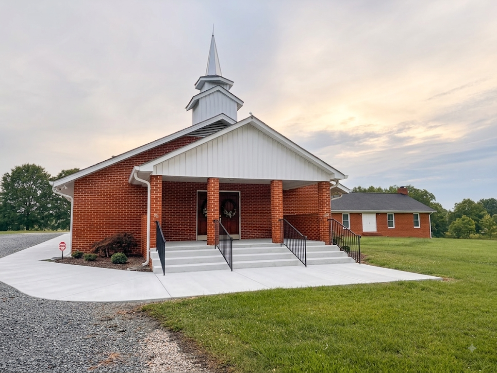 At The Cross Fellowship's church building in Monroe, NC, with its white steeple, at dusk.